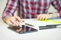Man on iPad Looking at Content Writing